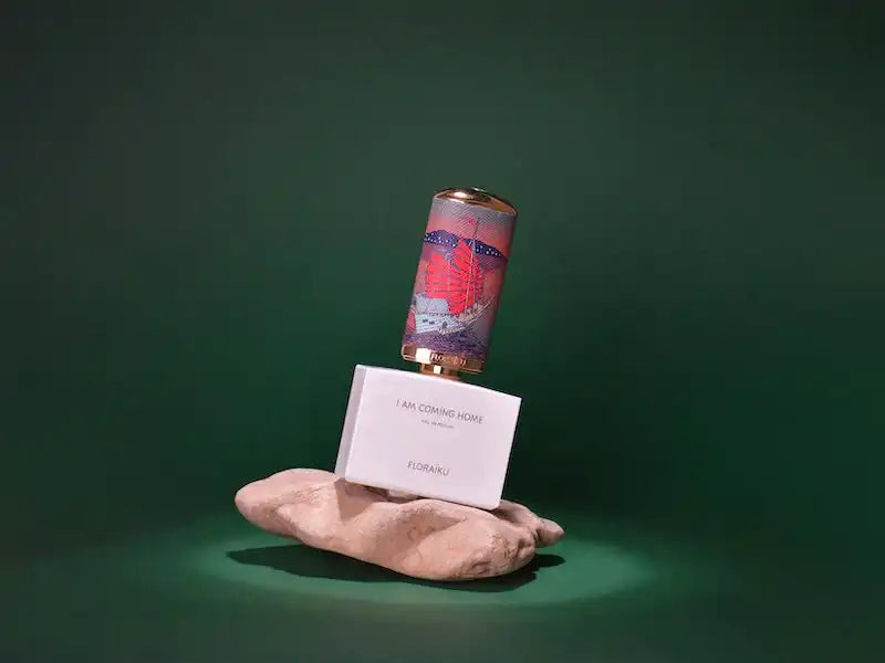 Pink soda can balanced on a white box atop ballet pointe shoes.